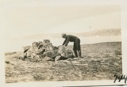 Image of MacMillan looking into Grave